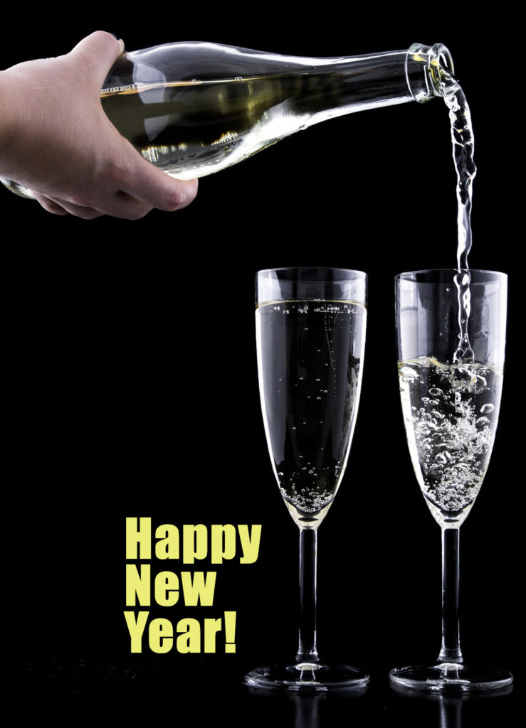 Champaign poured into two glasses with dark background and Happy New Year in yellow. Save money in your Asheville Home.