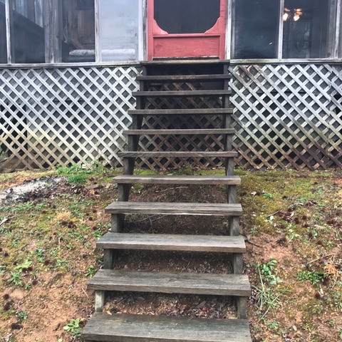 Unsafe stairs leading to a front door. Do-it-yourself additions.