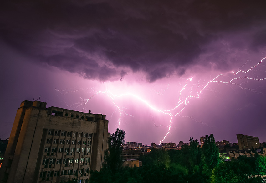 lightning strike over city buildings