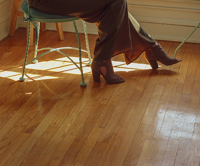 Chair, woman's feet on hardwood floor.
Asheville home's market value.